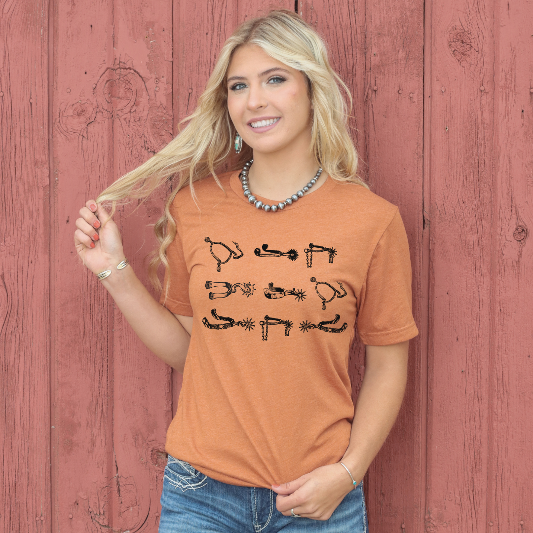 orange tshirt with spurs on front